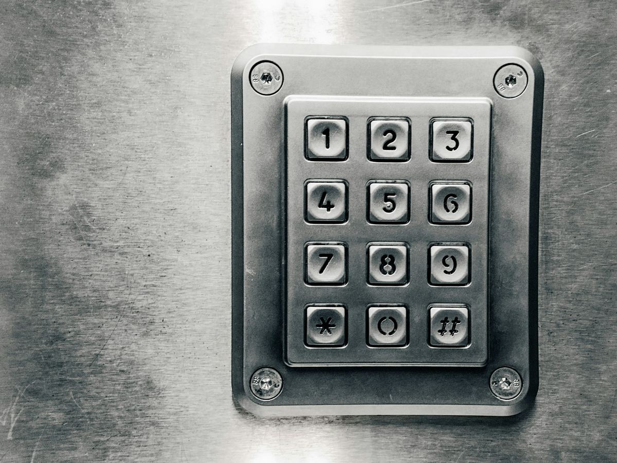 Close-up of a stainless steel access keypad with numbered buttons