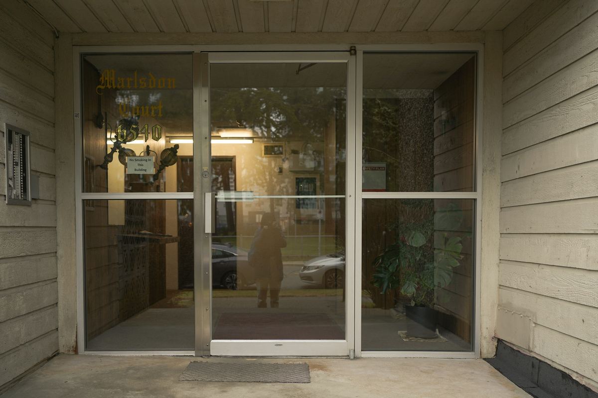 Aluminum storefront entrance with a pair of glass doors between glass sidelites, under a glass transom